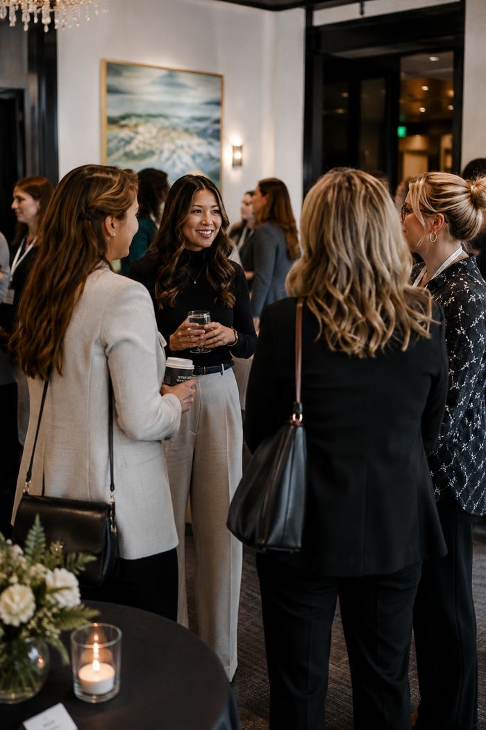 Attendees networking at a Women in Technology event